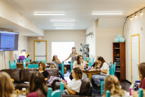 Photo: A group of women meet and work in a light-filled room.